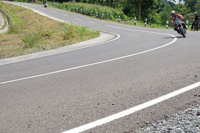 View of people riding bicycle on road