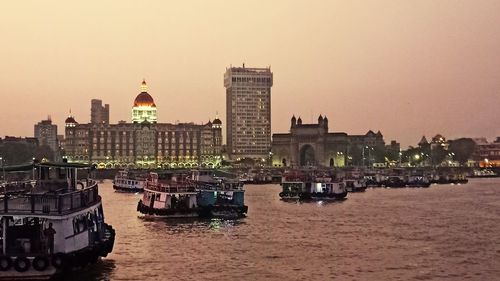 Boats in sea against buildings in city