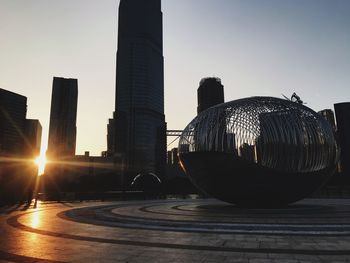 Modern buildings against sky during sunset in city