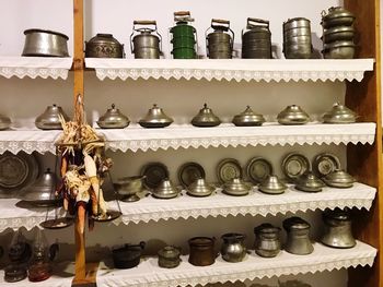 Close-up of bottles on shelf against wall