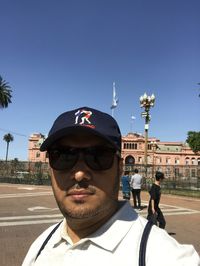 Portrait of man wearing sunglasses against clear sky