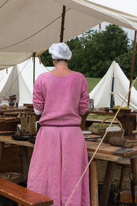 Rear view of woman working on wood