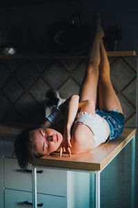 Young woman lying on floor at home