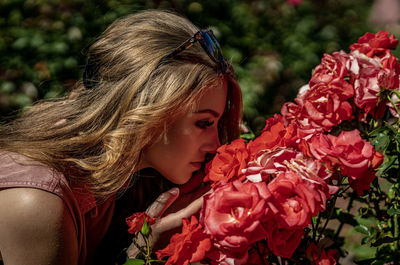 Close-up of woman with red flower