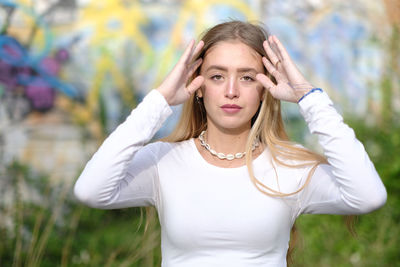 Portrait of beautiful young woman standing outdoors