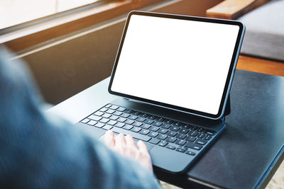 Midsection of woman using laptop on table