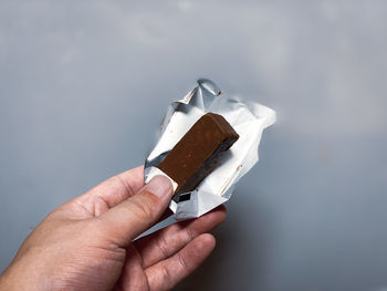 Close-up of hand holding ice cream