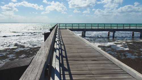 Pier over sea against sky