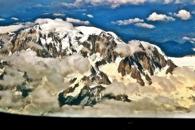 Scenic view of snow covered mountains against sky