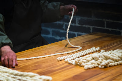 Midsection of man holding noodles