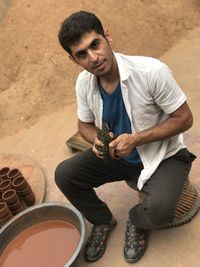 Portrait of young man sitting outdoors