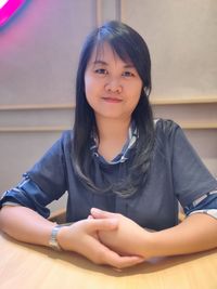 Portrait of young woman sitting on chair