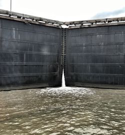 Water flowing against sky