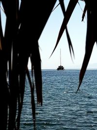 Silhouette boat in sea against sky