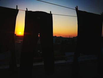 Silhouette buildings against sky during sunset