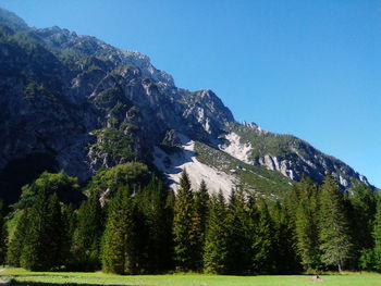 Scenic view of mountains against clear blue sky