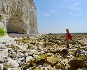 Woman standing on rocks at beach