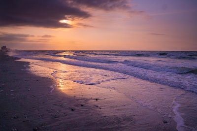 Scenic view of beach against sky during sunset