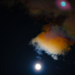 Low angle view of illuminated moon against sky at night