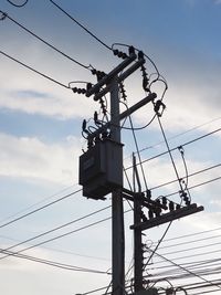 Low angle view of electricity pylon against sky