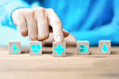 Close-up of baby hand with toy on table