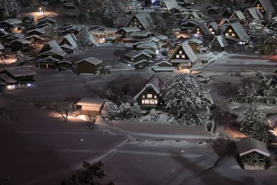 High angle view of illuminated buildings in city at night