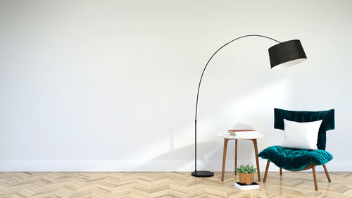 Table and chairs against white wall at home