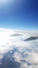 Scenic view of airplane wing against sky