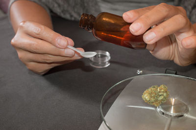 Close-up of person hand holding wineglass on table