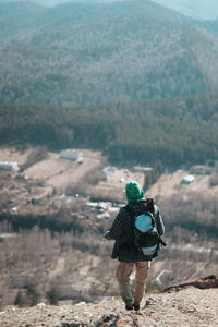 Rear view of man walking on mountain