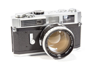 Close-up of old camera over white background