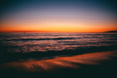 Scenic view of sea against romantic sky at sunset