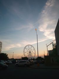 Cars on road against sky in city