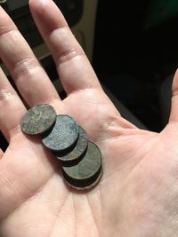 Close-up of hand holding coins