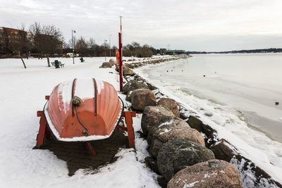 Snow covered land on field against sky