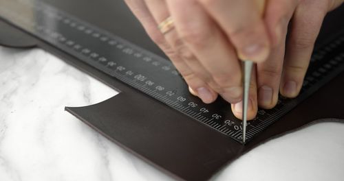 Cropped hands of man working on table