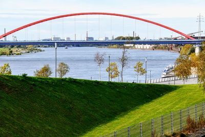 Arch bridge over river against sky