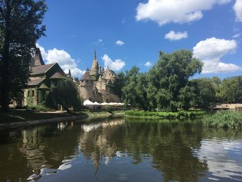 Reflection of trees and buildings on lake