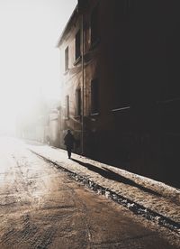 Silhouette person on road in winter