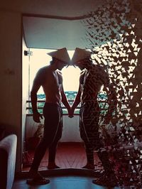 Rear view of woman standing at home