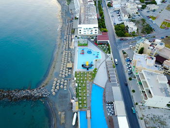 High angle view of swimming pool by buildings in city