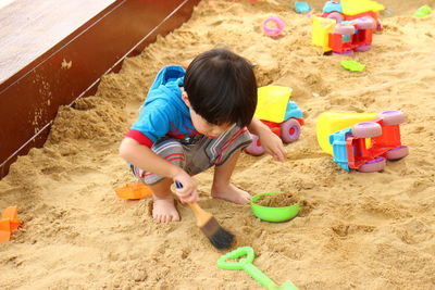 Boy playing on sand