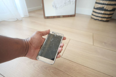 Cropped hands of woman using mobile phone