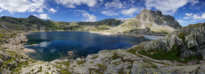 Scenic view of lake against cloudy sky