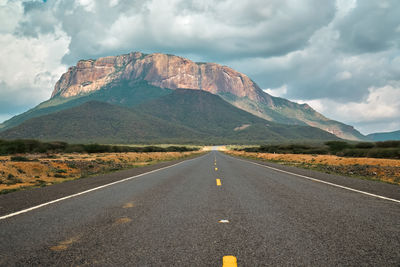 Road amidst mountains against sky