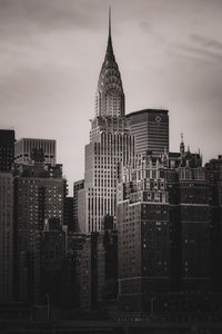 Buildings in city against sky during sunset