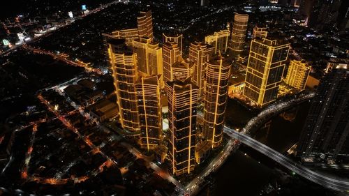 High angle view of illuminated buildings in city at night