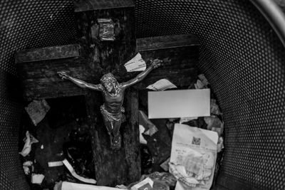 High angle view of crucifix in garbage bin