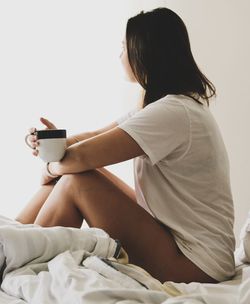 Side view of a young woman drinking coffee