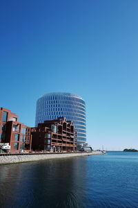 Low angle view of buildings against clear blue sky